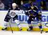Jeff Roberson / AP
Winnipeg Jets' Alexander Burmistrov, of Russia, and St. Louis Blues' Jay Bouwmeester, right, reach for a loose puck during the first period.