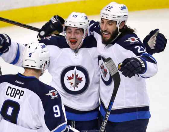 AP Photo/Charles KrupaWinnipeg Jets center Nicolas Petan, center, celebrates with Chris Thorburn (22) and Andrew Copp (9) after his goal against Boston Bruins goalie Tuukka Rask, of Finland, during the third period of an NHL hockey game in Boston.