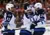 Alex Brandon / The Associated Press
Winnipeg Jets defenseman Dustin Byfuglien (33), center Mathieu Perreault (85) and right wing Blake Wheeler (26) celebrate a goal by Perreault.