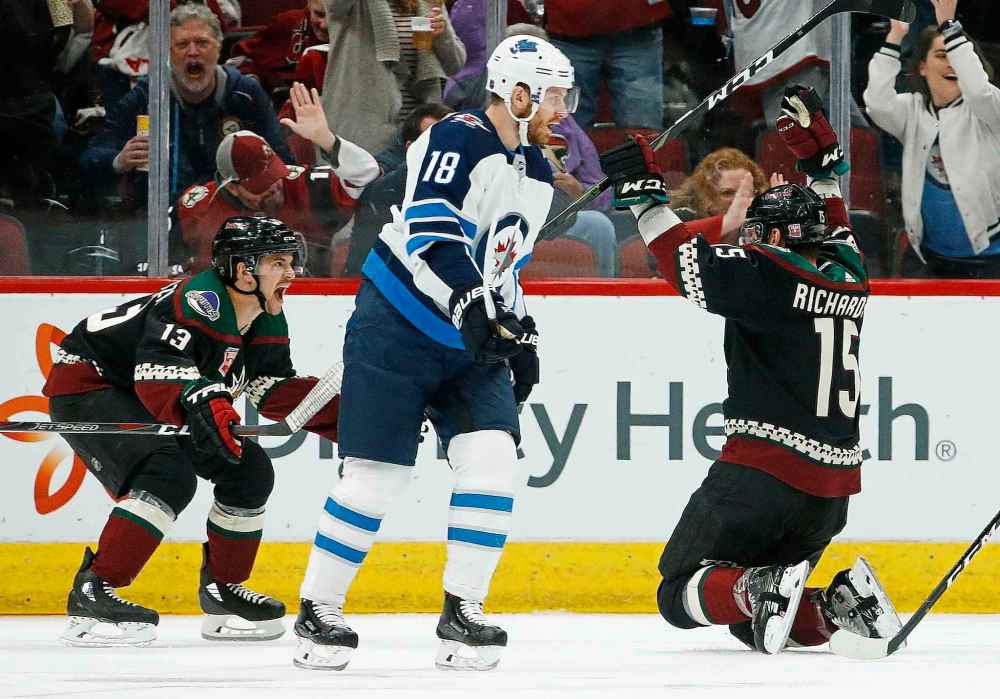 ROSS D. FRANKLIN / THE ASSOCIATED PRESS
Arizona Coyotes center Brad Richardson (15) celebrates his goal against the Winnipeg Jets with Coyotes' Vinnie Hinostroza (13) as Jets center Bryan Little (18) skates past during the first period of an NHL hockey game Sunday, Feb. 24, 2019, in Glendale, Ariz.