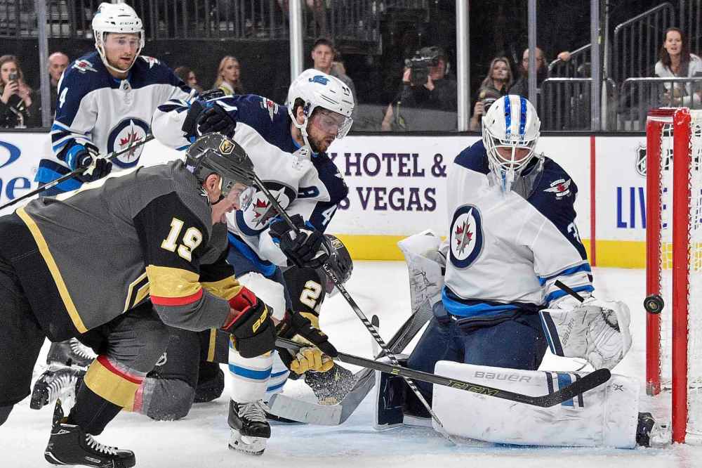 Vegas Golden Knights right wing Reilly Smith (19) shoots against Winnipeg Jets goaltender Laurent Brossoit during the second period of an NHL hockey game Saturday, Nov. 2, 2019, in Las Vegas. (AP Photo/David Becker)