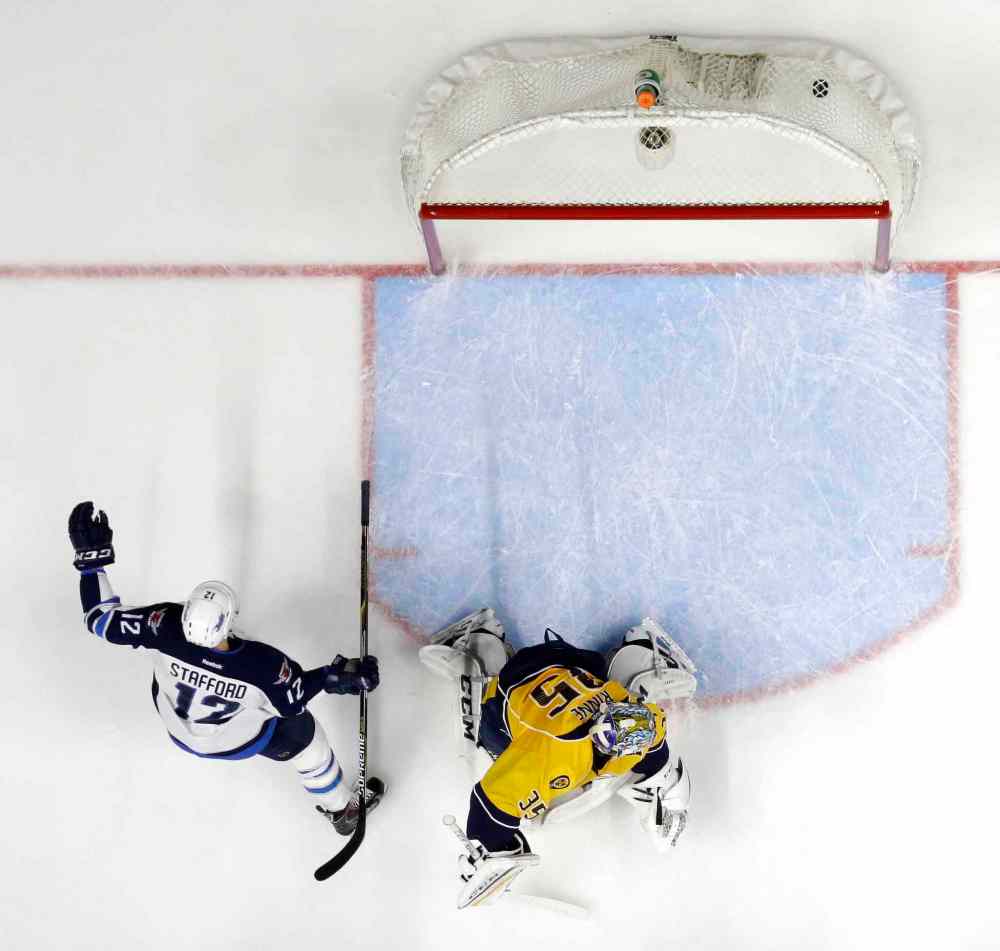 CP
Winnipeg Jets right wing Drew Stafford (12) celebrates after scoring a goal against Nashville Predators goalie Pekka Rinne (35), of Finland, in the second period of an NHL hockey game Tuesday, Jan. 5, 2016, in Nashville, Tenn. (AP Photo/Mark Humphrey)