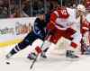 CP
Winnipeg Jets' Mark Scheifele (55) steals the puck from Detroit Red Wings' Jonathan Ericsson (52), of Sweden, during the first period of an NHL hockey game Thursday, March 10, 2016, in Detroit. (AP Photo/Duane Burleson)