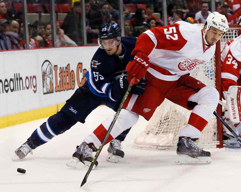 CP
Winnipeg Jets' Mark Scheifele (55) steals the puck from Detroit Red Wings' Jonathan Ericsson (52), of Sweden, during the first period of an NHL hockey game Thursday, March 10, 2016, in Detroit. (AP Photo/Duane Burleson)