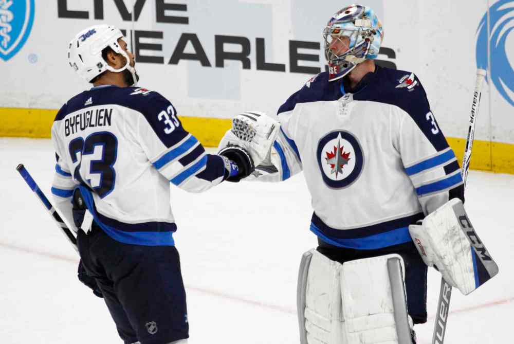 Jeffrey T. Barnes / The Associated Press files
Winnipeg Jets forward Dustin Byfuglien (33) and goalie Steve mason (35) celebrate a 7-4 victory over the Buffalo Sabres following the third period of an NHL hockey game, Tuesday, Jan. 9, 2018, in Buffalo, N.Y.