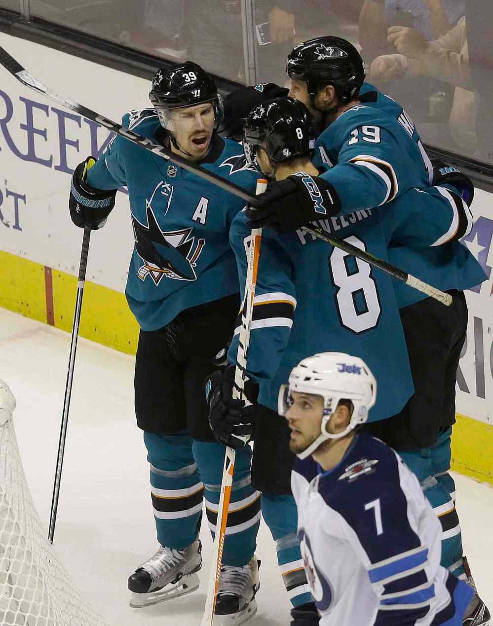 JEFF CHIU / THE ASSOCIATED PRESS
San Jose Sharks center Logan Couture, left, is congratulated by center Joe Pavelski (8) and center Joe Thornton (19) after scoring a goal against the Winnipeg Jets during the first period of an NHL hockey game in San Jose, Calif., Saturday, Nov. 25, 2017.