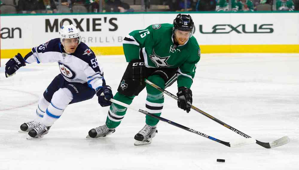 AP Photo/Mike Stone
Winnipeg Jets' Mark Scheifele (55) and Dallas Stars' Patrik Nemeth (15) battle for the puck during the first period of an NHL hockey game, Thursday, Jan. 7, 2016, in Dallas.
