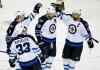 AP Photo/Hannah Foslien
Winnipeg Jets' Dustin Byfuglien (33), Jacob Trouba (8) and Andrew Ladd (16) congratulate right wing Blake Wheeler (26) on a goal against the Minnesota Wild during the first period of an NHL hockey game Friday, Jan. 15, 2016, in St. Paul, Minn.