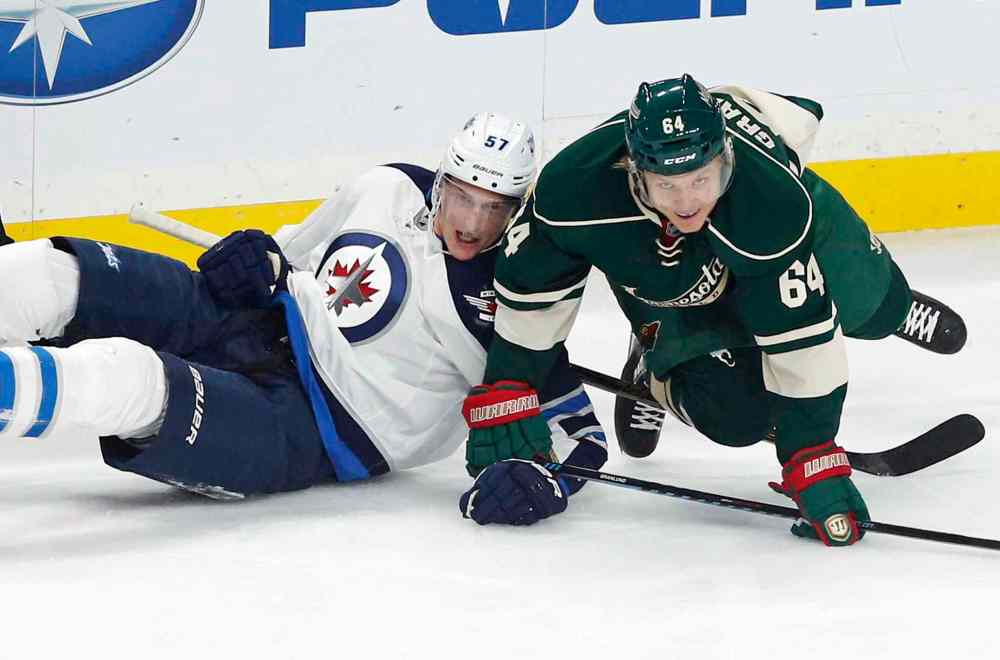 CP
Winnipeg Jets' Tyler Myers, left, and Minnesota Wild's Mikael Granlund, of Finland, hit the ice after colliding in the first period of an NHL hockey game Saturday, Oct. 15, 2016, in St. Paul, Minn. (AP Photo/Jim Mone)