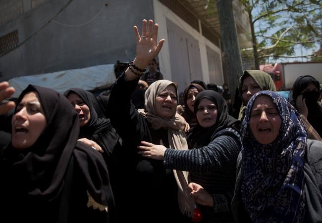 Relatives mourn Palestinian Raid Abu Tair, who was killed by Israeli troops during Friday's protest at the Gaza Strip's border with Israel, during his funeral in town of Khan Younis, Saturday, May. 4, 2019. Three Palestinians, including two militants, were killed by Israeli fire Friday after gunshots from the Gaza Strip wounded two Israeli soldiers, officials said, in a new flare-up that shattered a month-long easing of hostilities that was mediated by Egypt. (AP Photo/Khalil Hamra)