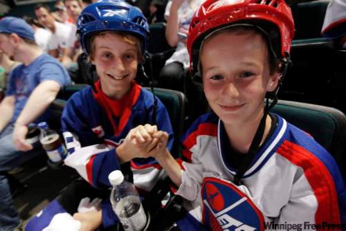JOHN WOODS
Cayden Kraus (left) and Joey Sabatini celebrate at the NHL draft party at the MTS Centre in Winnipeg Friday after it was announced the new NHL team's name will be the Jets.