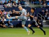 Sporting Kansas City midfielder Yohan Croizet, left, kicks the ball away from LA Galaxy midfielder Favio Alvarez during the first half of an MLS soccer match Wednesday, May 29, 2019, in Kansas City, Kan. (AP Photo/Charlie Riedel)