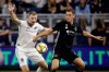 Colorado Rapids defender Tommy Smith, left, and Sporting Kansas City forward Krisztian Nemeth chase the ball during the first half of an MLS soccer match, Saturday, Sept. 21, 2019, in Kansas City, Kan. (AP Photo/Charlie Riedel)
