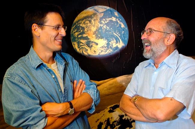 FILE - In this Thursday, Aug. 11, 2005 file photo Swiss Astronomers Michel Mayor, right, and Didier Queloz, left, pose for the photographer at the Astronomical Observatory of the University of Geneva. The 2019 Nobel prize in Physics was given to James Peebles