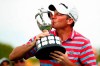 Jim Herman kisses the trophy after winning the PGA Barbasol Championship golf tournament final round at Keene Trace Golf Club's Champions Course in Nicholasville, Ky., Sunday, July 21, 2019. (Alex Slitz/Lexington Herald-Leader via AP)