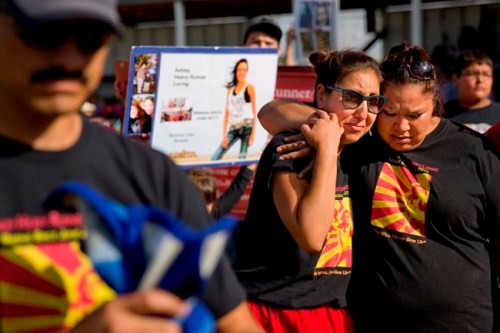 FILE - In this July 14, 2018 file photo, Jenna Loring, left, the aunt of Ashley HeavyRunner Loring, cries with her cousin, Lissa Loring, during a traditional blanket dance before the crowd at the North American Indian Days celebration on the Blackfeet Indian Reservation in Browning, Mont. Friday, April 26, 2019 marks the beginning of a two-day powwow in New Mexico that represents one of the largest annual gatherings of indigenous people in the United States. Organizers say they want to build awareness this year around the deaths and disappearances of Native American women. (AP Photo/David Goldman, File)