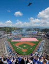 Fans stand for the national anthem as a C-17 Globemaster flies over before an opening day baseball game between the Los Angeles Dodgers and the Arizona Diamondbacks Thursday, March 28, 2019, in Los Angeles. (AP Photo/Mark J. Terrill)