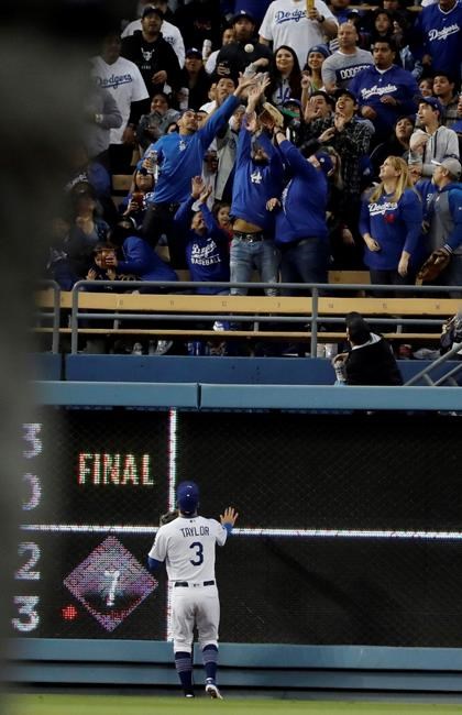 Los Angeles Dodgers left fielder Chris Taylor watches a home run by Washington Nationals' Howie Kendrick go over the wall during the first inning of a baseball game Thursday, May 9, 2019, in Los Angeles. (AP Photo/Marcio Jose Sanchez)