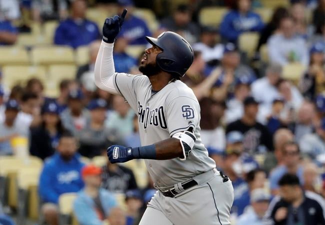 San Diego Padres' Franmil Reyes points skyward after hitting a solo home run against the Los Angeles Dodgers during the first inning of a baseball game Tuesday, May 14, 2019, in Los Angeles. (AP Photo/Marcio Jose Sanchez)
