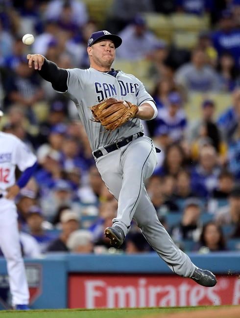 San Diego Padres third baseman Ty France attempts to throw out Los Angeles Dodgers' Corey Seager at first during the second inning of a baseball game Wednesday, May 15, 2019, in Los Angeles. Seager was safe at first on the play. (AP Photo/Mark J. Terrill)