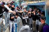 Colorado Rockies' Garrett Hampson is congratulated by teammates in their dugout after hitting a solo home run off Dodgers Hyun-Jin Ryu in the first inning inning of a baseball game in Los Angeles, Sunday, Sept. 22, 2019. (AP Photo/Sam Gangwer )