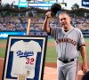 San Francisco Giants manager Bruce Bochy acknowledges the crowd after receiving a signed Sandy Koufax jersey to commemorate his last series at Dodger Stadium as Giants manager, prior to the team's baseball game against the Los Angeles Dodgers in Los Angeles, Friday, Sept. 6, 2019. (AP Photo/Kelvin Kuo)