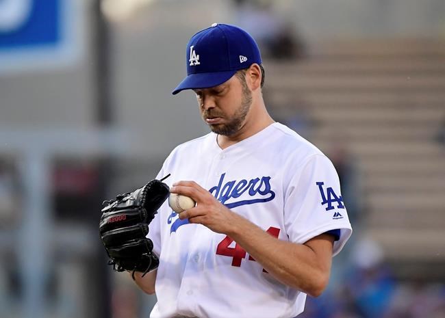Los Angeles Dodgers' Rich Hill gets set to pitch during the first inning of the team's baseball game against the San Francisco Giants on Wednesday, June 19, 2019, in Los Angeles. (AP Photo/Mark J. Terrill)