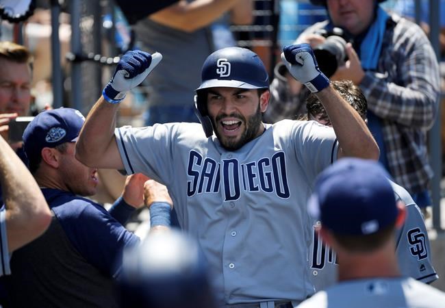 San Diego Padres' Eric Hosmer celebrates his grand slam in the dugout during the third inning of a baseball game against the Los Angeles Dodgers Sunday, Aug. 4, 2019, in Los Angeles. (AP Photo/Mark J. Terrill)