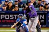 Colorado Rockies' Nolan Arenado hits a solo home run in front of Los Angeles Dodgers catcher Will Smith during the first inning of a baseball game Friday, Sept. 20, 2019, in Los Angeles. (AP Photo/Mark J. Terrill)