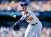 Los Angeles Dodgers first baseman Cody Bellinger tosses the ball to first base to force out San Francisco Giants' Kevin Pillar on a bunt-attempt during the fourth inning of a baseball game in Los Angeles, Sunday, Sept. 8, 2019. (AP Photo/Kelvin Kuo)