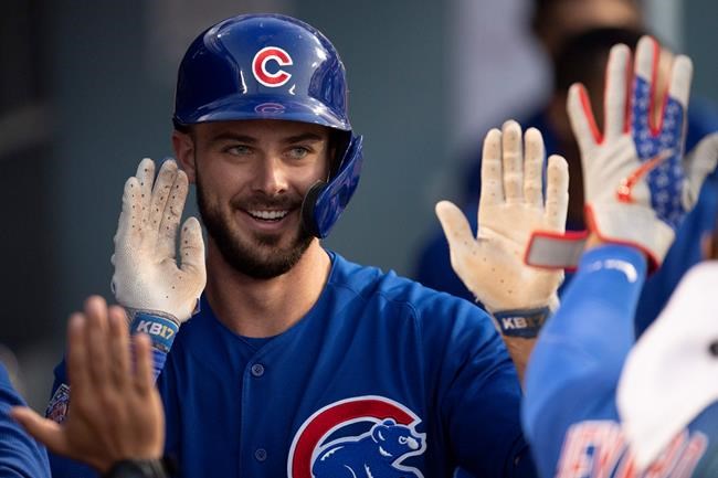 Chicago Cubs' Kris Bryant smiles in the dugout after his solo home run during the third inning of the team's baseball game against the Los Angeles Dodgers in Los Angeles, Friday, June 14, 2019. (AP Photo/Kyusung Gong)