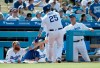 Los Angeles Dodgers' David Freese, center, is congratulated by Justin Turner, left, and coach Bob Geren, right, after scoring on a bases-loaded walk during the first inning of a baseball game against the Chicago Cubs in Los Angeles, Sunday, June 16, 2019. (AP Photo/Alex Gallardo)