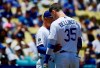 Los Angeles Dodgers manager Dave Roberts, left, talks with Cody Bellinger after Bellinger hit a fan with a foul ball during the first inning of a baseball game against the Colorado Rockies, Sunday, June 23, 2019, in Los Angeles. (AP Photo/Mark J. Terrill)