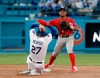 Washington Nationals shortstop Wilmer Difo, top, completes a double play over Los Angeles Dodgers' Alex Verdugo (27) on ground ball from Enrique Hernandez during the second inning of a baseball game Saturday, May 11, 2019, in Los Angeles. (AP Photo/Marcio Jose Sanchez)