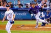 Colorado Rockies' Josh Fuentes, center, runs to first as he hits a solo home run while Los Angeles Dodgers starting pitcher Walker Buehler, left, and catcher Russell Martin watch during the seventh inning of a baseball game Saturday, Sept. 21, 2019, in Los Angeles. (AP Photo/Mark J. Terrill)
