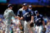 Milwaukee Brewers starting pitcher Jhoulys Chacin, center, is relieved by manager Craig Counsell during the third inning of a baseball game against the Los Angeles Dodgers, Sunday, April 14, 2019, in Los Angeles. (AP Photo/Jae C. Hong)