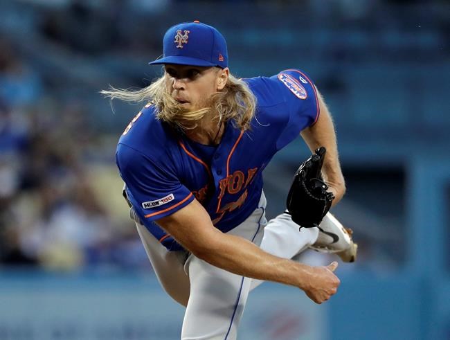 New York Mets starting pitcher Noah Syndergaard watches a throw to a Los Angeles Dodgers batter during the second inning of a baseball game Wednesday, May 29, 2019, in Los Angeles. (AP Photo/Marcio Jose Sanchez)