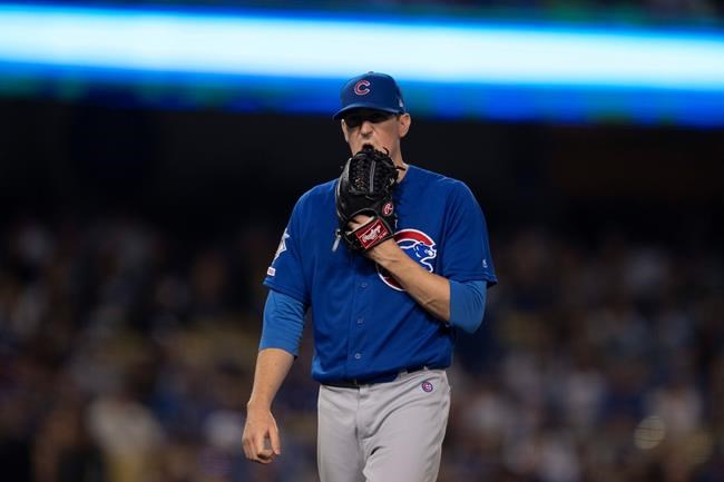 Chicago Cubs starting pitcher Kyle Hendricks walks off the field after being removed from the baseball game against the Los Angeles Dodgers during the fifth inning in Los Angeles, Friday, June 14, 2019. (AP Photo/Kyusung Gong)