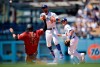 Los Angeles Dodgers shortstop Chris Taylor, center, throws to first after forcing out Arizona Diamondbacks' Wilmer Flores, left, to complete a double play during the fourth inning of a baseball game as Enrique Hernandez looks on in Los Angeles, Sunday, March 31, 2019. Ildemaro Vargas was out at first base. (AP Photo/Kelvin Kuo)