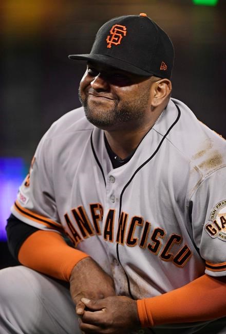San Francisco Giants third baseman Pablo Sandoval winces after having his hand stepped on while forcing out Los Angeles Dodgers' Max Muncy during the fifth inning of a baseball game, Monday, June 17, 2019, in Los Angeles. (AP Photo/Mark J. Terrill)