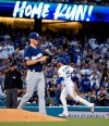 Los Angeles Dodgers' Cody Bellinger, right, rounds third after hitting a solo home run as Milwaukee Brewers starting pitcher Zach Davies stands at the mound during the fourth inning of a baseball game Saturday, April 13, 2019, in Los Angeles. (AP Photo/Mark J. Terrill)