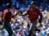 Arizona Diamondbacks' Ketel Marte, right, celebrates with Jake Lamb after both scoring off a two-run double by Nick Ahmed during the fourth inning of an MLB baseball game against the Los Angeles Dodgers in Los Angeles, Sunday, March 31, 2019. (AP Photo/Kelvin Kuo)