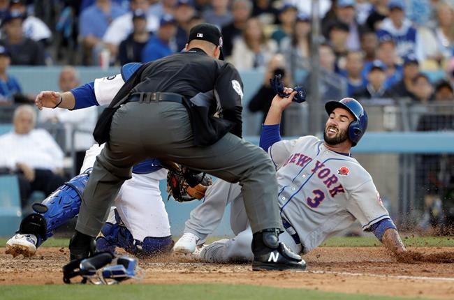 New York Mets' Tomas Nido, right, is tagged by Los Angeles Dodgers catcher Russell Martin as Nido tried to score on a double by Amed Rosario during the fifth inning of a baseball game Monday, May 27, 2019, in Los Angeles. (AP Photo/Marcio Jose Sanchez)