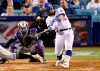 Los Angeles Dodgers' Russell Martin hits a three-run home run in front of Colorado Rockies catcher Tony Wolters and home plate umpire Dan Bellino during the seventh inning of a baseball game Tuesday, Sept. 3, 2019, in Los Angeles. (AP Photo/Mark J. Terrill)