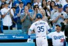 Los Angeles Dodgers' Cody Bellinger gets congratulations from manager Dave Roberts, right, after Bellinger hits a solo home run against the Chicago Cubs during the sixth inning of a baseball game in Los Angeles, Sunday, June 16, 2019. (AP Photo/Alex Gallardo)