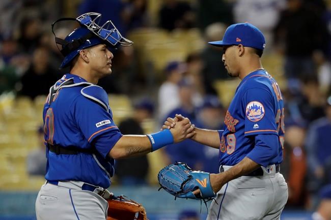 New York Mets relief pitcher Edwin Diaz, right, and catcher Wilson Ramos celebrate after their win against the Los Angeles Dodgers in a baseball game in Los Angeles, Tuesday, May 28, 2019. The Mets won 7-3. (AP Photo/Chris Carlson)