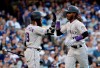 Colorado Rockies' Raimel Tapia, right, celebrates his solo home run with Charlie Blackmon during the seventh inning of the team's baseball game against the Los Angeles Dodgers on Saturday, June 22, 2019, in Los Angeles. (AP Photo/Marcio Jose Sanchez)