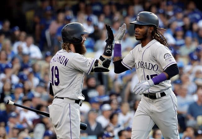 Colorado Rockies' Raimel Tapia, right, celebrates his solo home run with Charlie Blackmon during the seventh inning of the team's baseball game against the Los Angeles Dodgers on Saturday, June 22, 2019, in Los Angeles. (AP Photo/Marcio Jose Sanchez)