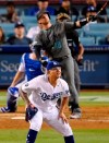 Arizona Diamondbacks' Carson Kelly, top, hits a solo home run as Los Angeles Dodgers relief pitcher Julio Urias reacts during the 11th inning of a baseball game Friday, Aug. 9, 2019, in Los Angeles. (AP Photo/Mark J. Terrill)