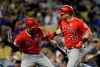 Los Angeles Angels' Kole Calhoun, right, celebrates his solo home run with teammate Andrelton Simmons during the seventh inning of a baseball game against the Los Angeles Dodgers, Tuesday, July 23, 2019, in Los Angeles. (AP Photo/Marcio Jose Sanchez)